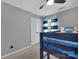 Cozy bedroom with a bunk bed, soft carpet, neutral walls, and a bright window with patterned curtains at 15737 Agincourt Dr, Huntersville, NC 28078