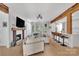 Open concept living space with a modern fireplace, dining bar and lots of natural light at 15737 Agincourt Dr, Huntersville, NC 28078