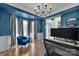 Stylish blue office space with elegant lighting and a comfortable seating area at 15737 Agincourt Dr, Huntersville, NC 28078