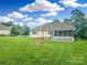 Expansive backyard with lush green grass and a screened porch, perfect for outdoor entertaining at 1625 Damascus Cir, Conover, NC 28613