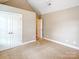 Bedroom with neutral decor featuring plush carpet, a closet, and an en-suite at 1625 Damascus Cir, Conover, NC 28613