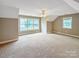 Spacious bedroom featuring two windows, neutral decor, and plush carpet at 1625 Damascus Cir, Conover, NC 28613