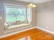 Cozy dining area with a built-in window seat, hardwood floors, and chandelier lighting at 1625 Damascus Cir, Conover, NC 28613