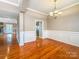 Open dining room with hardwood floors and decorative molding leading to the kitchen and fireplace at 1625 Damascus Cir, Conover, NC 28613