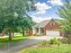 Attractive brick home with landscaped front yard, paved driveway, and attached two-car garage at 1625 Damascus Cir, Conover, NC 28613
