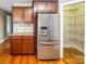 Kitchen area with stainless steel refrigerator, custom cabinets, and granite counters at 1625 Damascus Cir, Conover, NC 28613