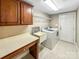 Well-equipped laundry room features built-in cabinets, countertops, sink, and appliances at 1625 Damascus Cir, Conover, NC 28613