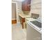 Bright laundry room with front-loading washer, sink, ample counter space, and storage cabinets at 1625 Damascus Cir, Conover, NC 28613