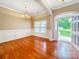 Inviting living room with wood floors, decorative molding, and an open front door at 1625 Damascus Cir, Conover, NC 28613