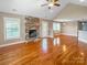 Inviting living room with stone fireplace, vaulted ceilings, hardwood floors, and a cozy window seat at 1625 Damascus Cir, Conover, NC 28613