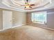 Comfortable carpeted bedroom with a tray ceiling and a large window seat for relaxing at 1625 Damascus Cir, Conover, NC 28613