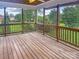 Cozy screened porch with wood floors and railings offers scenic outdoor views at 1625 Damascus Cir, Conover, NC 28613