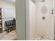 Tiled shower with pebbled floor in well-lit bathroom with stone floor at 1645 Brookdale Ave, Charlotte, NC 28210