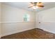 Cozy bedroom features hardwood floors, a ceiling fan, and a window with great natural light at 1645 Brookdale Ave, Charlotte, NC 28210