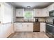Bright kitchen with white cabinetry, stainless steel appliances, and modern tile backsplash at 1645 Brookdale Ave, Charlotte, NC 28210