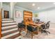 Bright home office space with wooden desk, built-in bookcase, and staircase in view at 1645 Brookdale Ave, Charlotte, NC 28210