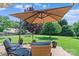 Backyard deck featuring outdoor furniture, an umbrella, and a large grassy lawn at 166 Rumple Hill Dr, Statesville, NC 28677