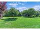 Expansive backyard featuring a lush lawn, mature trees, and storage shed at 166 Rumple Hill Dr, Statesville, NC 28677