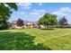 Large backyard showcasing ample green space and mature trees surrounding the home at 166 Rumple Hill Dr, Statesville, NC 28677