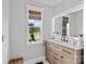Bright bathroom with light wood vanity, backlit mirror and stylish fixtures at 166 Rumple Hill Dr, Statesville, NC 28677