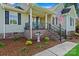 Inviting front porch with brick accents, decorative plants, and comfortable seating, enhancing curb appeal at 166 Rumple Hill Dr, Statesville, NC 28677