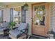 Close-up of a charming front porch with a decorative wreath and cozy seating arrangement at 166 Rumple Hill Dr, Statesville, NC 28677