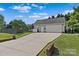 Detached two-car garage with an extended driveway and well-manicured landscaping at 166 Rumple Hill Dr, Statesville, NC 28677