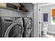 Laundry area featuring front load washer and dryer with overhead storage at 166 Rumple Hill Dr, Statesville, NC 28677