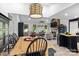 Spacious living area view with fireplace, connecting to the dining area with farmhouse-style table at 166 Rumple Hill Dr, Statesville, NC 28677