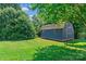 Backyard storage shed featuring a gable roof, painted wood siding, and green space at 166 Rumple Hill Dr, Statesville, NC 28677