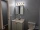 Bathroom with a vanity sink, toilet, and Hollywood-style lighting at 1660 Songwood Rd, Concord, NC 28025