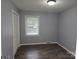 Bedroom features neutral paint, window overlooking yard, and closet at 1660 Songwood Rd, Concord, NC 28025