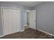Bedroom featuring bi-fold closet doors, natural light, and wood-look flooring at 1660 Songwood Rd, Concord, NC 28025