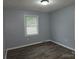 Bedroom featuring neutral paint, natural light, and wood-look flooring at 1660 Songwood Rd, Concord, NC 28025