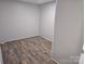 Basement bedroom featuring laminate flooring, neutral paint, and a doorway at 1660 Songwood Rd, Concord, NC 28025