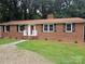 Traditional brick house with black shutters, a red front door, and a well-maintained lawn at 1660 Songwood Rd, Concord, NC 28025