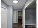 Inviting hallway with fresh paint and flooring, leading to various rooms in the home at 1660 Songwood Rd, Concord, NC 28025