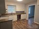 Bright kitchen features white cabinetry, modern countertops, and hardwood flooring at 1660 Songwood Rd, Concord, NC 28025