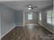 Bright living room with hardwood floors, multiple windows, and ceiling fans at 1660 Songwood Rd, Concord, NC 28025
