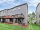 Rear exterior featuring a wood deck, green grass, and grey siding at 1723 Town Oak Ln, Charlotte, NC 28205