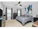 Cozy bedroom with a ceiling fan, a geometric patterned bedspread, and stylish window treatments at 1723 Town Oak Ln, Charlotte, NC 28205