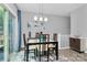 Bright dining room featuring modern lighting, stylish decor, sliding door and a chic area rug at 1723 Town Oak Ln, Charlotte, NC 28205