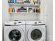 Laundry room featuring a side-by-side washer and dryer with storage shelves at 1723 Town Oak Ln, Charlotte, NC 28205