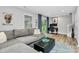 Comfortable living room with grey sofa, natural light, hardwood floors, and decor at 1723 Town Oak Ln, Charlotte, NC 28205