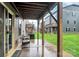 Covered patio with seating area overlooking a green lawn and neighboring townhomes at 1723 Town Oak Ln, Charlotte, NC 28205