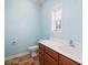 Bathroom featuring tile floor, toilet, wood cabinets, white sink and countertop at 181 Singleton Rd, Mooresville, NC 28117