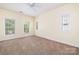 Spacious bedroom featuring neutral walls, carpet, ceiling fan, and multiple windows at 181 Singleton Rd, Mooresville, NC 28117