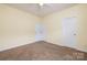 Bedroom featuring carpet, neutral walls, and closet and white paneled door at 181 Singleton Rd, Mooresville, NC 28117