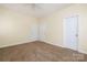 Bedroom with neutral carpet and walls featuring two closets and a white paneled door at 181 Singleton Rd, Mooresville, NC 28117
