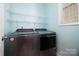 Functional laundry room with modern washer and dryer and shelving at 181 Singleton Rd, Mooresville, NC 28117